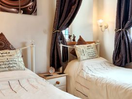 A bedroom with two beds and decorative elements at Kaber Chapel in Kaber near Kirby Stephen