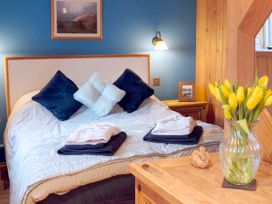 A bedroom with a bed and flowers at Kaber Chapel in Kaber near Kirby Stephen