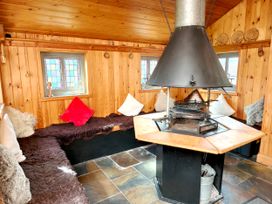 A snug with seating area and central fireplace at Kaber Chapel in Kaber near Kirby Stephen