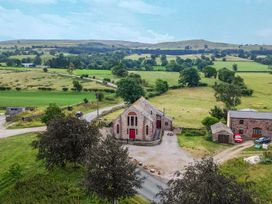 A building and cars near fields at Kaber Chapel in Kaber near Kirkby Stephen