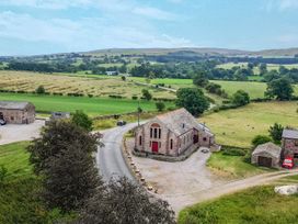 An exterior view of a building near a road with fields in the background at Kaber Chapel in Kaber near Kirkby Stephen