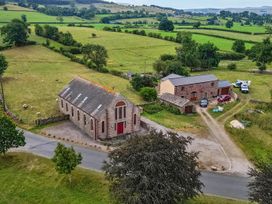 An aerial view of a building and vehicles in a field at Kaber Chapel near Kirkby Stephen