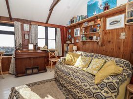 A living room with a sofa and bookshelf at The Cabin 