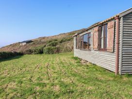 An outdoor area with a cabin and grass at The Cabin in 