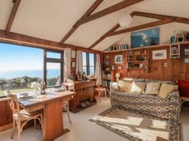 A living room with a dining table and sofa at The Cabin