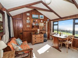 A living room with a table and chairs at The Cabin in 