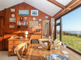 A dining room with a table set for meals at The Cabin 