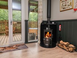 A room with a fireplace and wooden door at Robins Nest Lodge South Molton