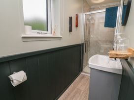 A bathroom with a shower and sink at Robins Nest Lodge South Molton