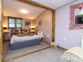 A bedroom with a bed and decorative elements at Hedgehogs Lodge in South Molton