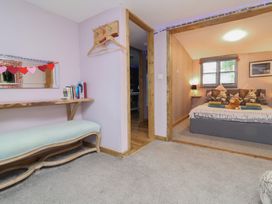 A bedroom with a bed and pillows at Hedgehogs Lodge in South Molton