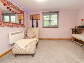 A snug with a chaise longue and a table at Hedgehogs Lodge in South Molton