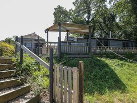 An outdoor area with steps leading to a deck at Hedgehogs Lodge South Molton