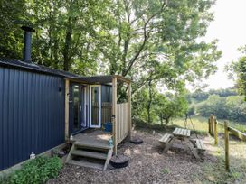 An outdoor area with a picnic table and steps at Valley View Shepherd's Hut in South Molton