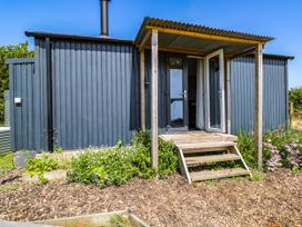 A hut with steps and flower beds at Hares Hideaway Shepherd's Hut South Molton