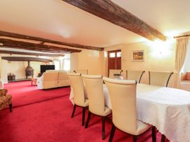 A dining room with a table and chairs at The Farmhouse in Keswick