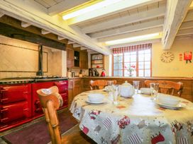 A kitchen with a table set for dining at The Farmhouse in Keswick