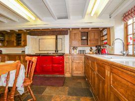 A kitchen with cabinets and a stove at The Farmhouse in Keswick