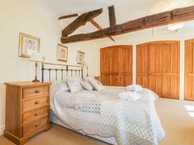 A bedroom with a bed and wardrobe at The Farmhouse in Keswick
