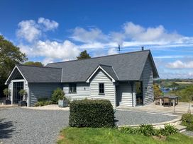 A house with a patio and garden area at Wood Meadow in Helston