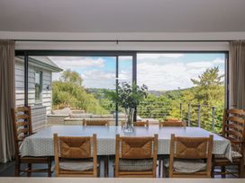 A dining room with a table and chairs at Wood Meadow in Helston