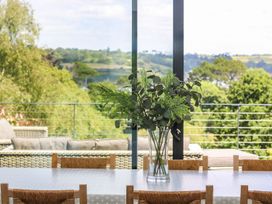 A dining room with plants on a table at Wood Meadow in Helston
