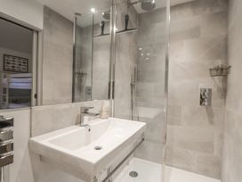 A bathroom with a shower and sink at Wood Meadow in Helston