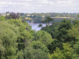 A view with trees and water featuring boats at Wood Meadow in Helston