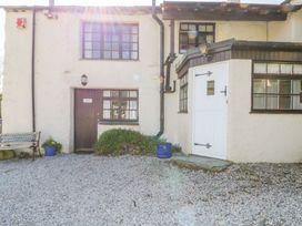 An outdoor area with a door, windows, and a bench at Farmhouse Cottage in Keswick