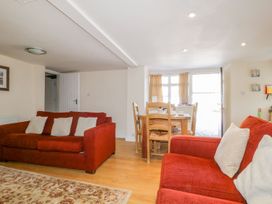 A living room with a sofa and dining table at Farmhouse Cottage in Keswick