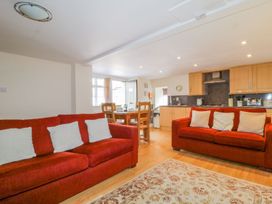 A living room with a dining area and kitchen at Farmhouse Cottage in Keswick
