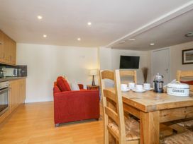 A living room with a dining table and sofa at Farmhouse Cottage in Keswick