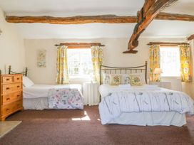 A bedroom with a double bed and a single bed at Farmhouse Cottage in Keswick