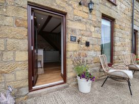 An entrance with chairs and flowers at Wren's Nest in Lealholm