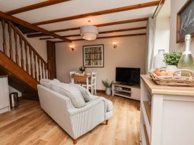 A living room with a sofa and dining table at Wren's Nest in Lealholm