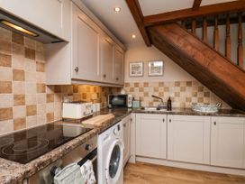 A kitchen with appliances and cabinets at Wren's Nest in Lealholm