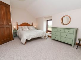 A bedroom with a bed and dresser at Wren's Nest in Lealholm