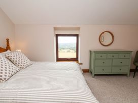 A bedroom with a bed and dresser at Wren's Nest in Lealholm