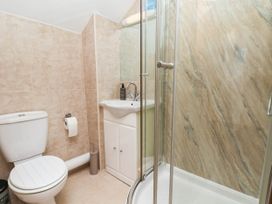A bathroom with a shower, toilet, and sink at Wren's Nest in Lealholm