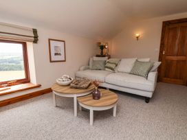 A snug with a sofa and coffee table at Swallow Cottage in Lealholm