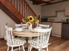 A kitchen with a dining table and chairs at Swallow Cottage in Lealholm