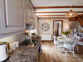 A kitchen with dining area at Swallow Cottage in Lealholm