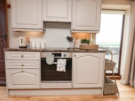 A kitchen with cabinets and oven at Swallow Cottage in Lealholm