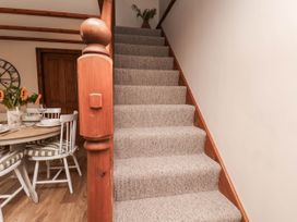 A staircase leading to an upper floor in a dining room at Swallow Cottage Lealholm