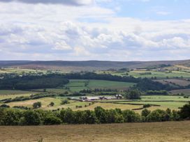 A landscape view with fields and trees at Swallow Cottage in Lealholm