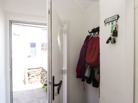 An entrance with a coat rack and a door at Bobbin Nook