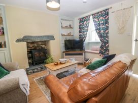 A living room with a fireplace and a television at Bobbin Nook