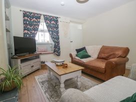 A living room with a sofa and television at Bobbin Nook 