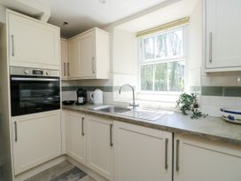 A kitchen featuring cabinets, sink and oven at Bobbin Nook