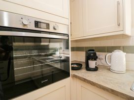 A kitchen with an oven and coffee machine at Bobbin Nook